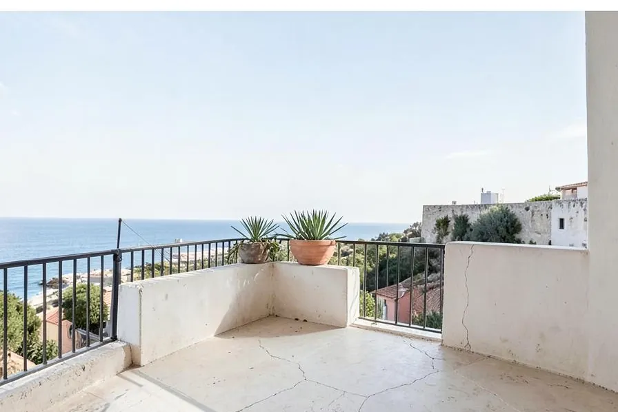A bare concrete balcony before its transformation