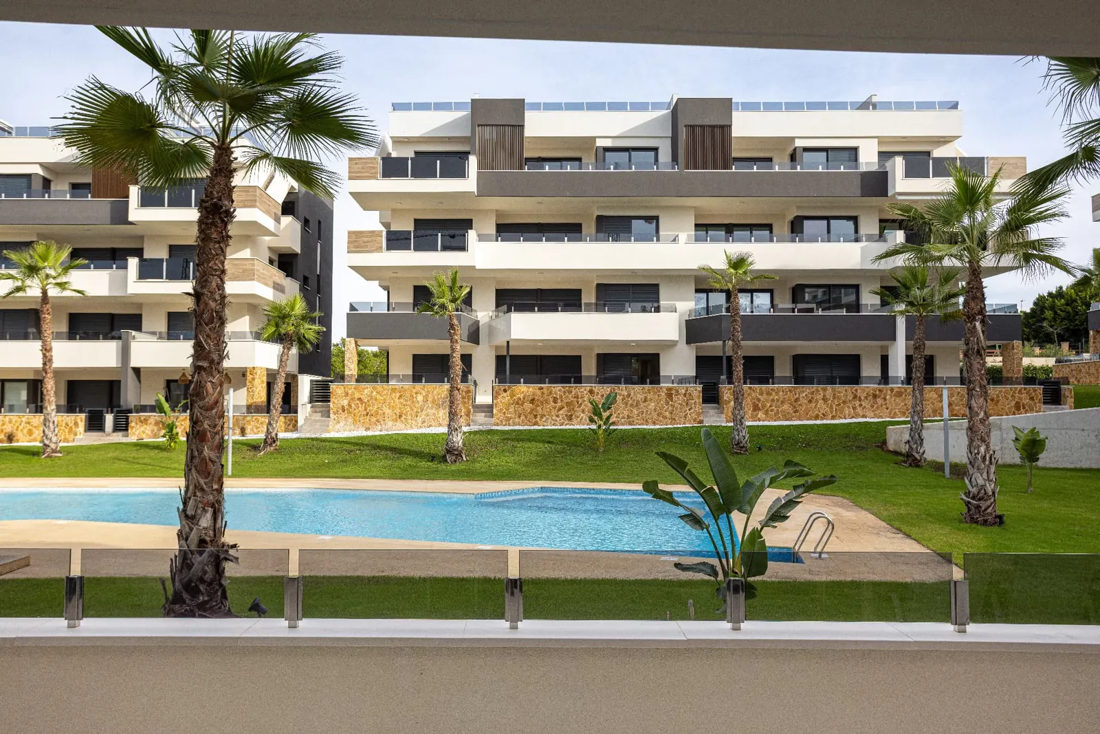 A contemporary Algarve condominium with landscaped shared grounds and swimming pool