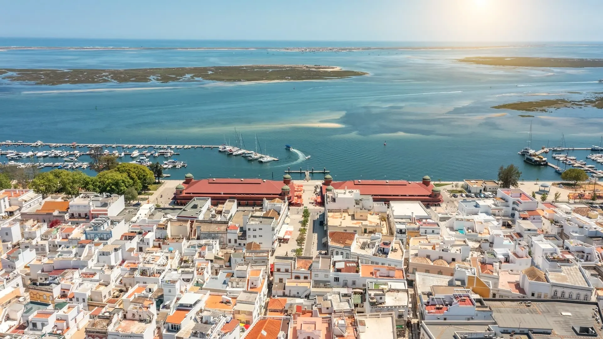 Aerial view of Olhão harbour, town rooftops and the Ria Formosa lagoon