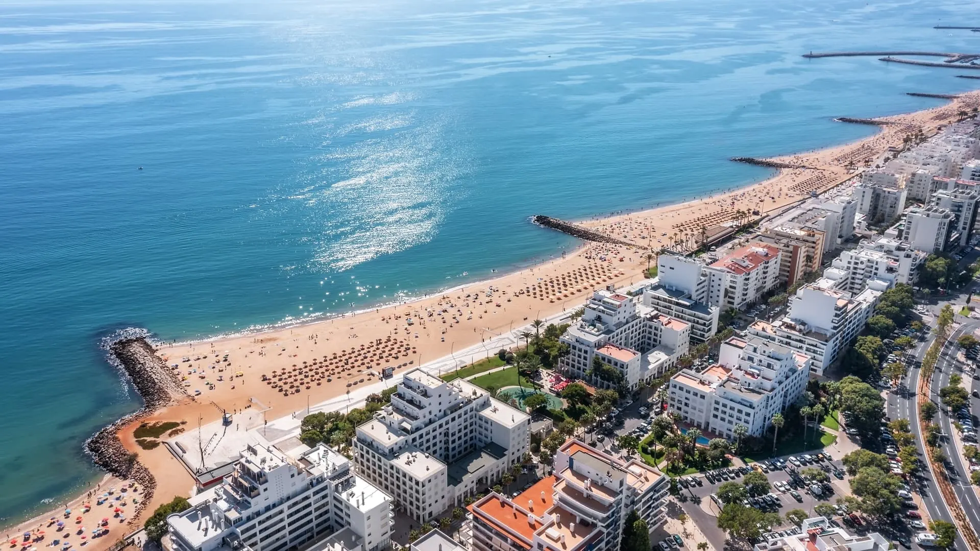 Aerial view of Quarteira's sandy beach and seafront apartment buildings
